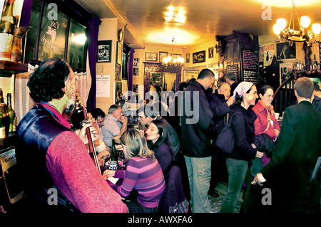 PARIS, France, Large Crowd French Bistro Restaurant, Wine Bar 'Les Pipos'  Interior Musician performing in pub busy, local neighborhood bar interior Stock Photo