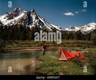 Fly fisherman casting for trout in a small creek in Sawtooth National Recreation Area of Central Idaho. Stock Photo