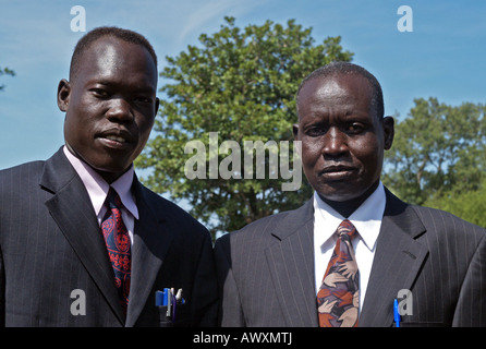 In a village in South Sudan, a young man and his uncle dress in Western suits for an important meeting about tribal conflict. Stock Photo