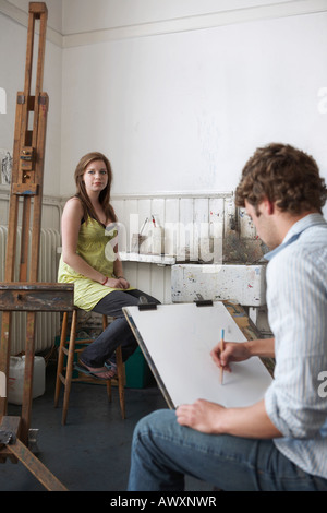 Student sketching model in art class Stock Photo