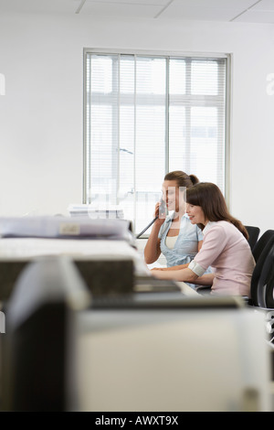 Two women working in office, side view Stock Photo