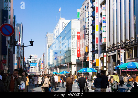 People walking and shopping along Chuo Dori street on Sunday in upscale Ginza district of Tokyo Japan Stock Photo