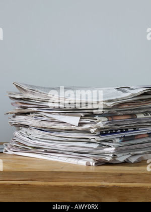 Stack of newspapers on table Stock Photo