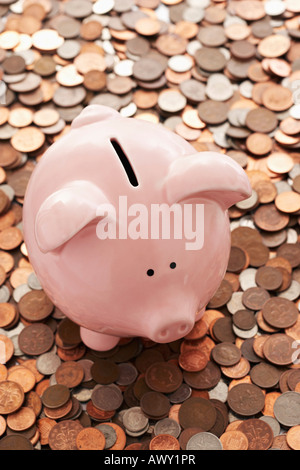 Piggy bank and vast amount of coins Stock Photo