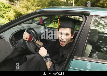 Young graduate wearing a cap and gown Stock Photo