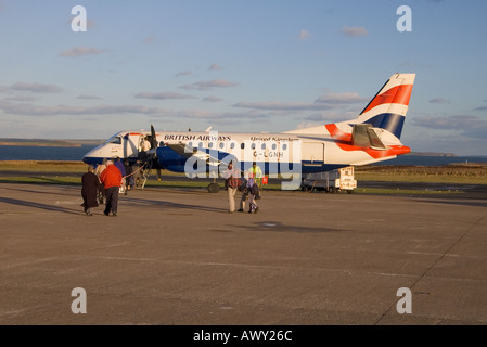 dh British airways 340b KIRKWALL AIRPORT ORKNEY SCOTLAND Passengers boarding BA aeroplane Saab 340 on runway