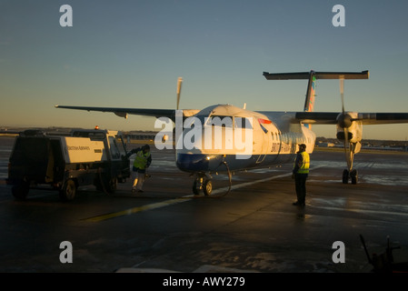 dh  DYCE AIRPORT ABERDEEN British Airways Dash 8 refuelling early morning runway ba an airplane on the ground Stock Photo