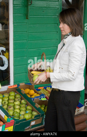 Woman buying vegetables and picking fruit from farm shop and fruit   Tarleton Lancashire, uk Stock Photo