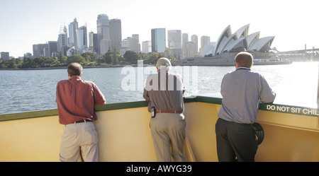 Manly ferry leaves Circular Quay with Sydney and Opera House behind Stock Photo