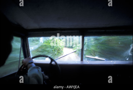Old landrover driving on extremely rough bush track, Ngezi Forest Reserve, Pemba, Zanzibar, Tanzania Stock Photo