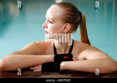 Young woman in a swimming pool at a spa Stock Photo