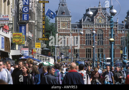 The Damrak in Amsterdam the Netherlands with Central Station in the distance Stock Photo