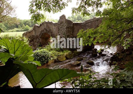 UK, Somerset Dunster Castle garden bridge over River Avill Stock Photo