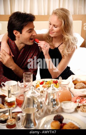 Couple having breakfast in hotel room Stock Photo