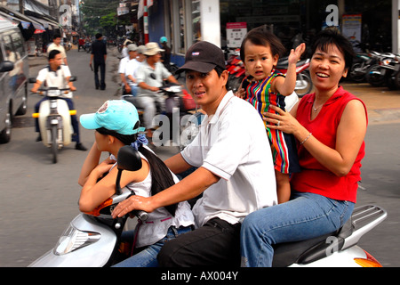 Asia Far East Vietnam , Ho Chi Minh City or Saigon , typical family outing with four on Honda motor bike , mother , father , daughter & son Stock Photo