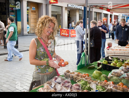 Woman at Dundee farmers food and craft christmas market; City centre stalls selling foods & agricultural produce to browsing shoppers. Scotland UK Stock Photo