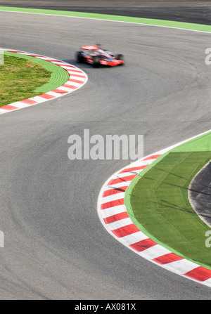 Formula 1 Racecar speeds through double bend curve in racetrack Stock ...