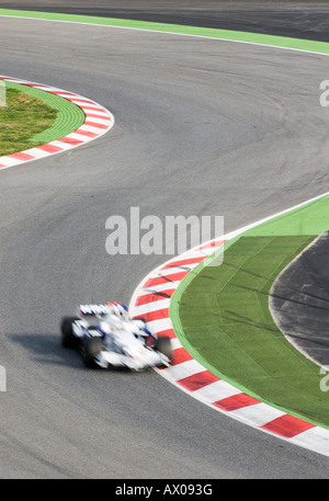 Formula 1 Racecar speeds through double bend curve in racetrack Stock ...