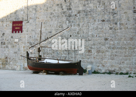 Old sailing vessel alongside stone wall Dubrovnik Croatia Stock Photo