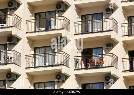 identical rows of balconies in bright sun on hotel in Benidorm. Stock Photo