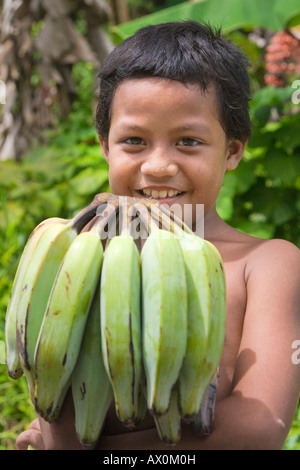 Child holding bananas, Pohnpei, Federated States of Micronesia Stock Photo