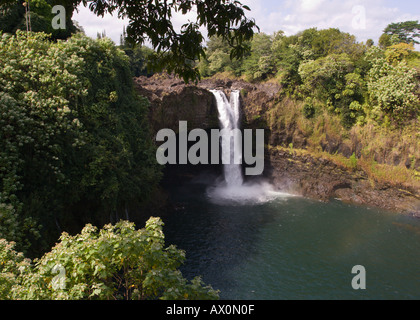 Rainbow Falls and greenery on the Wailuku River framed by overhead tree in the State Park near Hilo on Big Island Hawaii Stock Photo