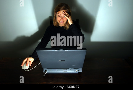 woman working at laptop computer with stress Stock Photo