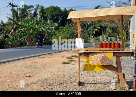 Used liquor bottles filled with gasoline for sale at a petrol station in Kho Chang, Gulf of Thailand, Thailand, Southeast Asia, Stock Photo