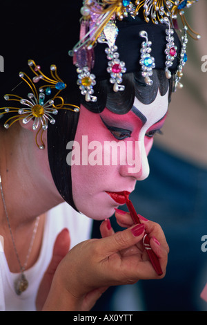 China, Hong Kong, Portrait of Chinese Opera Actress Applying Make-up Stock Photo