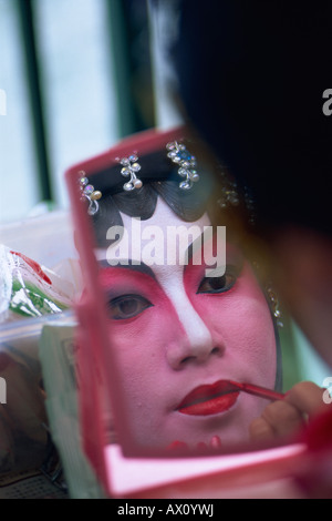 China, Hong Kong, Portrait of Chinese Opera Actress Applying Make-up Stock Photo