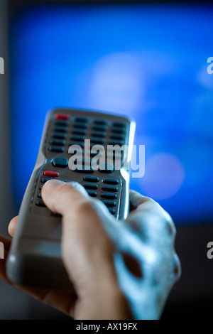 Hand holding a remote control Stock Photo