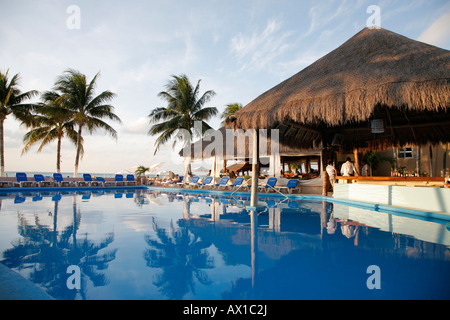 Bar and swimming pool on the beach, sunset, Isla Mujeres, cancun, Mexico Stock Photo