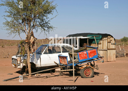 Car and donkey cart in front of a small barrack, Namibia, Africa Stock Photo