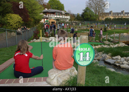 Young children playing crazy golf Stock Photo