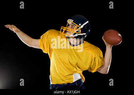 An American football player throwing a ball Stock Photo