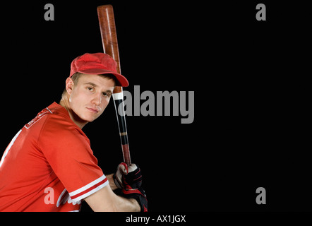 A baseball player holding a baseball bat Stock Photo