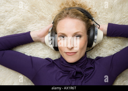 A woman wearing old-fashioned headphones Stock Photo