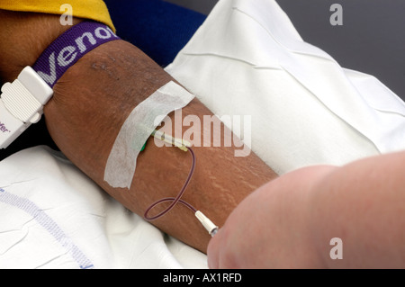 Patient having butterfly inserted into vein Stock Photo