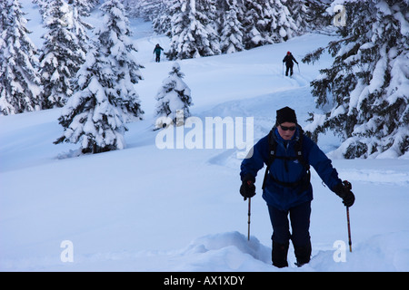 Snowshoers at Mt. Schildenstin near Tegernsee lake in Bavaria, Germany, Europe Stock Photo