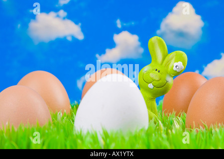 Easter bunny hiding behind eggs Stock Photo