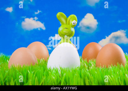 Easter bunny hiding behind eggs Stock Photo