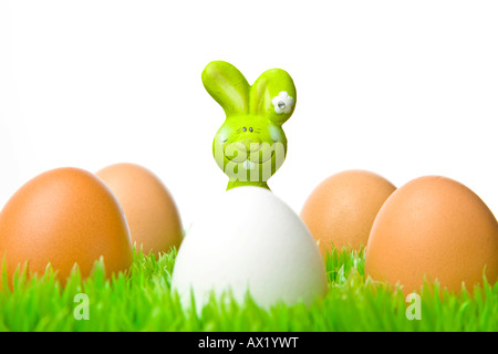 Easter bunny hiding behind eggs Stock Photo