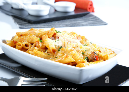 Penne au gratin with fish seafood and grated cheese Stock Photo