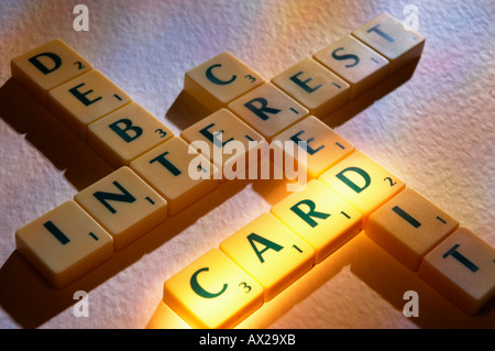 SCRABBLE BOARD GAME LETTERS SPELLING CREDIT CARD INTEREST DEBT Stock Photo