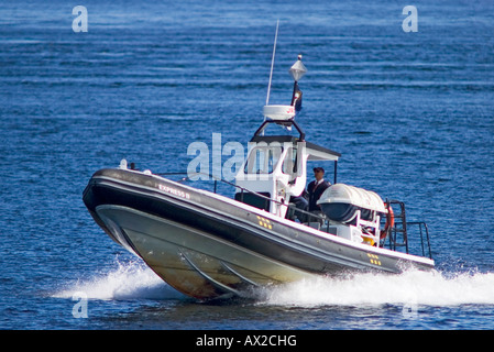 One man piloting an emptied pneumatic boat on St-Lawrence river at Tadoussac Stock Photo