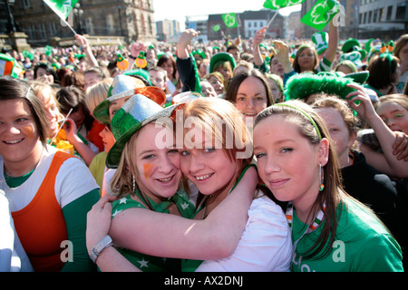young teenage irish girls at the front of the crowd at the st patricks day concert and carnival in custom house square belfast n Stock Photo