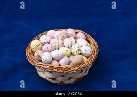 Mini easter eggs in a small basket. Stock Photo