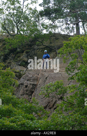 Rock Climber wearing safety harness and rope Stock Photo