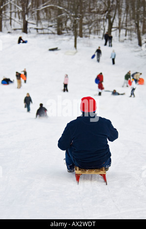 Teenage Boy Sledding Down Hill in Cherokee Park Louisville Kentucky Stock Photo