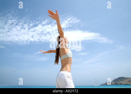 Beach wellness young woman doing a yoga excercise well being wellbeing wellness serene fit fitness vitality Stock Photo